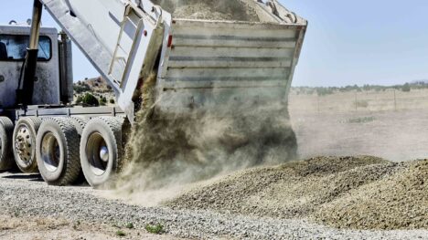 Car unloading material outside