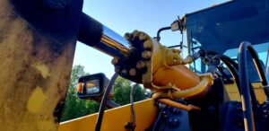 Yellow hydraulic cylinder being operated outside