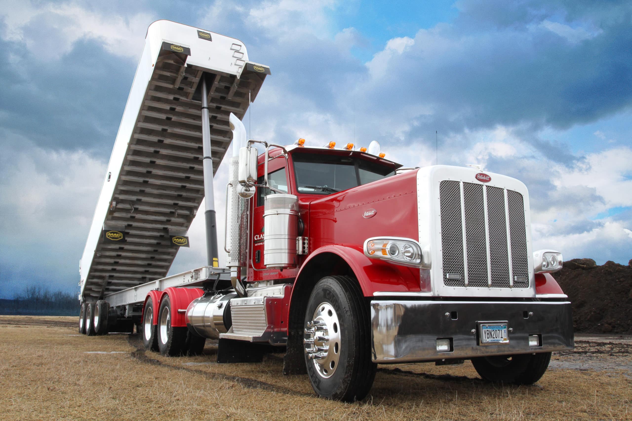 Large Red Dump Truck with Lift Trailer