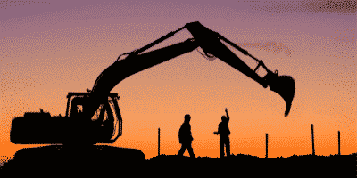 construction workers working during sunset