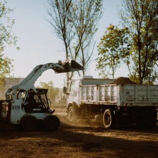 skidsteer-dumping-dirt-in-dump-truck