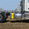 Hyva aluminum side-mount wet kit oil tank installed on a truck chassis behind the cab